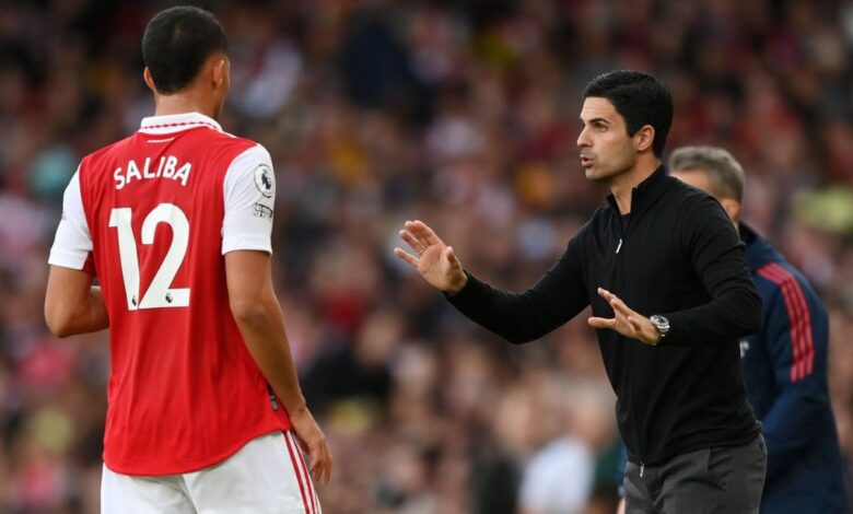 Arsenal manager Mikel Arteta speaks to William Saliba during the Premier League match between Arsenal FC and Liverpool FC at Emirates Stadium on October 09, 2022 in London, England.