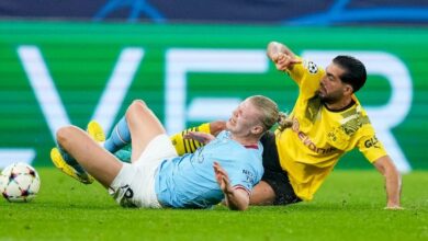 Erling Haaland is challenged by Emre Can during Manchester City