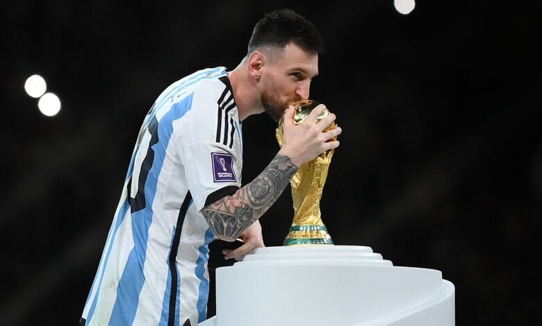 Inter Miami target Lionel Messi of Argentina kisses The FIFA World Cup Qatar 2022 Winner